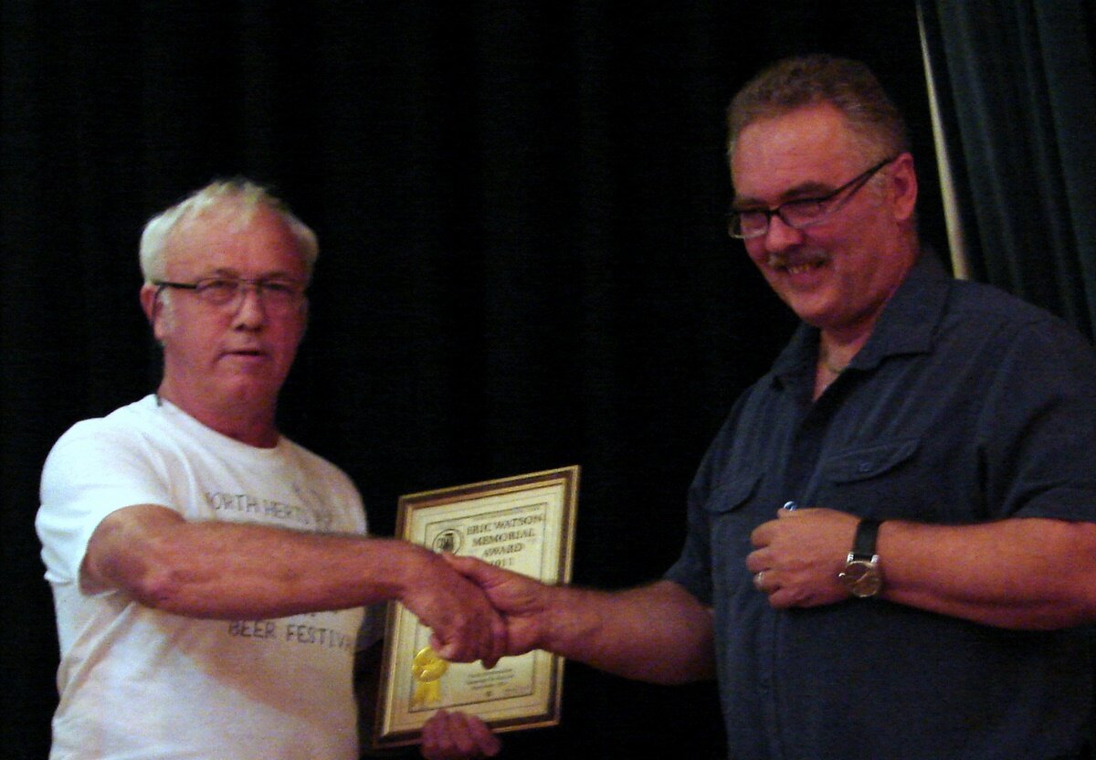 Brian Mason presents Dennis Hill with an Eric Watson award