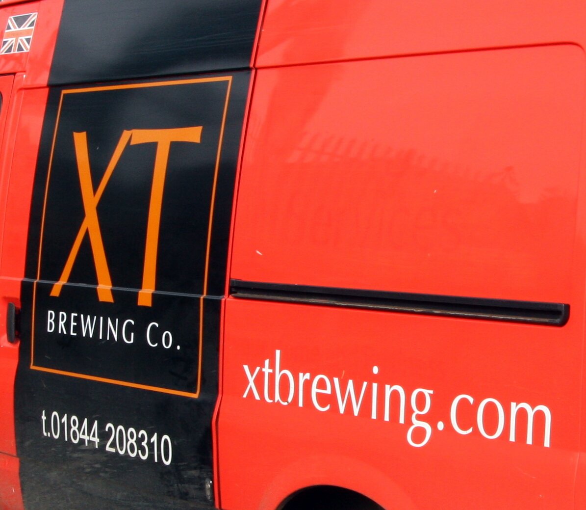XT Brewing Company's bright delivery van.